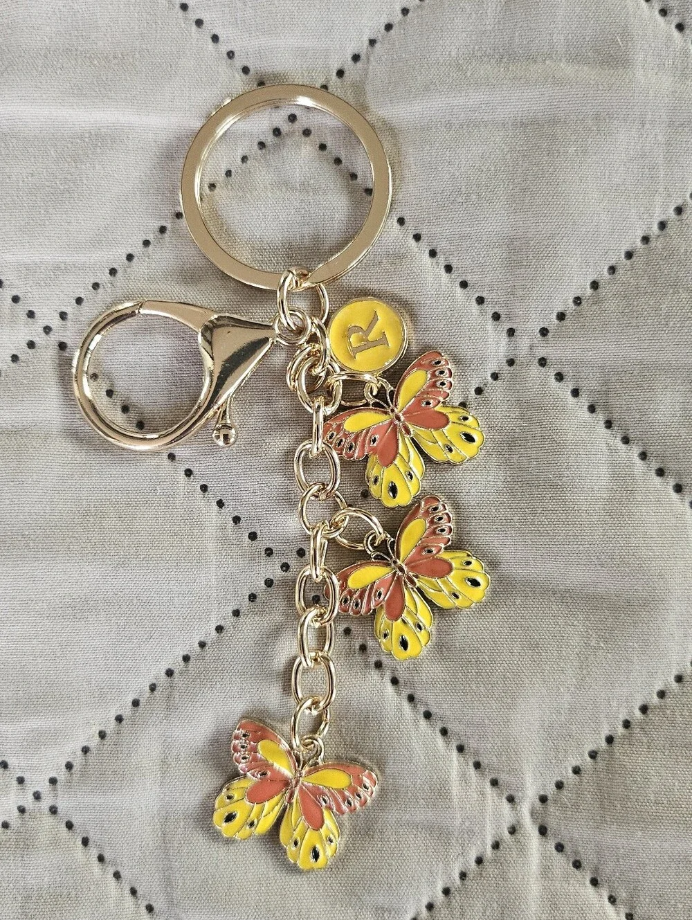 Yellow butterfly keyring, keychain. Bag charm. Has an R charm but can be removed